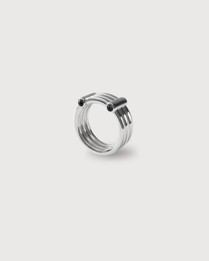 Silver 3 band ring with black accents on a light gray background