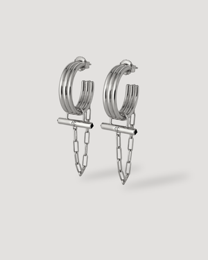 Modern silver ADIRA Rod Hoop Earrings by CVLCHA featuring a sculptural hoop, polished rod detail and signature chain drop.