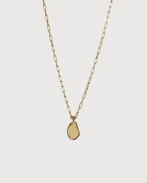 Cvlcha Gold necklace with a geometric pendant on a light gray background