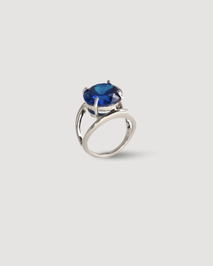 Cvlcha Azura Silver ring with a brilliant cut round blue 5A Cubic Zirconia on a light grey background