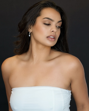 Model wearing Arc Hoops sterling silver with natural moonstones in a studio setting
