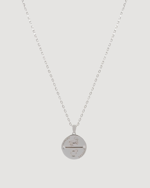 Cvlcha Aries Zodiac Silver necklace with a round pendant on a light gray background