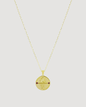 Cvlcha Capricorn Zodiac Gold Necklace  with a round pendant on a light grey background