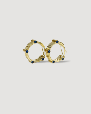 EDGE Sapphire Blue Hoop Earrings by CVLCHA featuring premium 5A sapphire blue cubic zirconia in a modern sculptural hoop design.