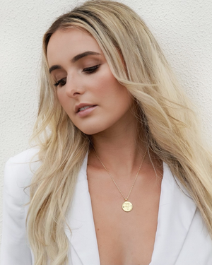 Fashion shot of female wearing CVLCHA Gemini Gold Necklace 