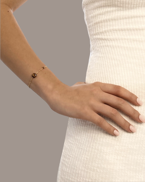 Model wearing the Iris Tiger Eye Bracelet by CVLCHA styled with modern neutral fashion for effortless everyday elegance.
