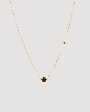 up close product shot of the Cvlcha tiger eye gold necklace 