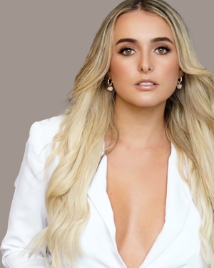 Model with blonde hair wearing modern gold hoop earrings featuring natural rose quartz gemstones suspended from textured hoops, designed for everyday wear by CVLCHA.