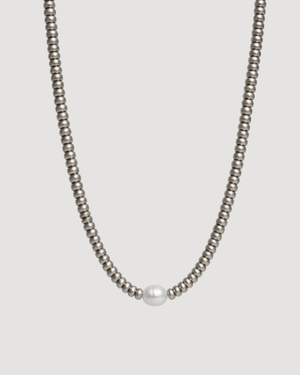 A modern trend Silver Pearl necklace with a white center pearl against a light grey background. trending Pearl necklace Australia