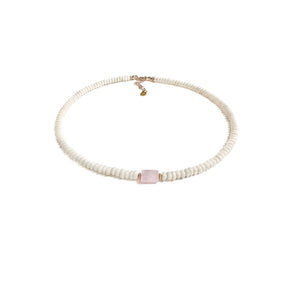 sandra rose quartz gemstone surrounded by white coral