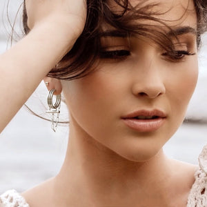 ADIRA Crystal Rod Hoop Earrings Silver- CVLCHA- model posing with earrings 